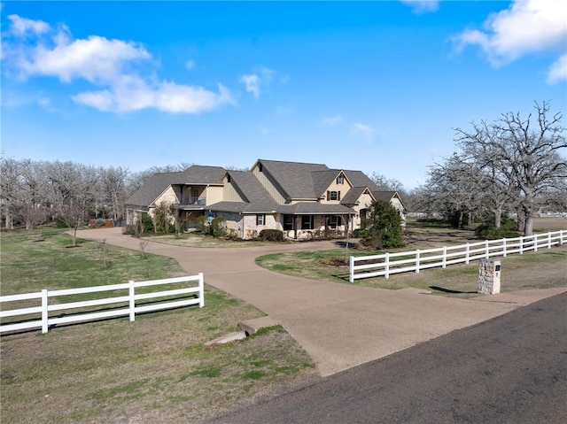 view of front of property featuring a rural view and fence