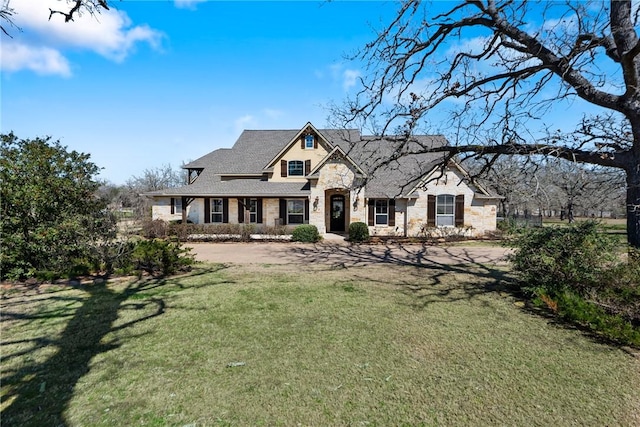 view of front of house featuring stone siding and a front lawn