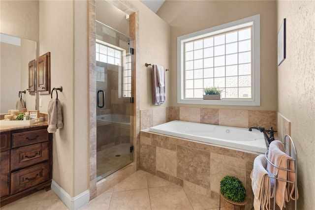 full bathroom featuring tile patterned flooring, a shower stall, a wealth of natural light, and vanity