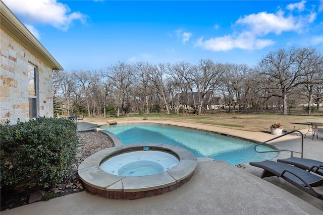 view of swimming pool with a patio and a pool with connected hot tub