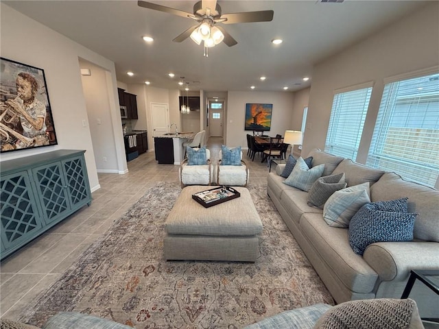 living room with ceiling fan and sink