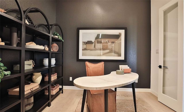 interior space with light wood-style floors and baseboards