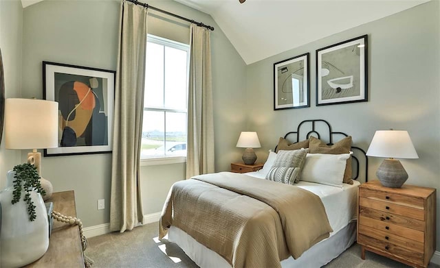 bedroom with vaulted ceiling, multiple windows, baseboards, and light colored carpet