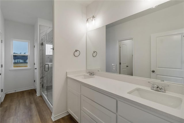 bathroom with vanity, wood-type flooring, and a shower with shower door