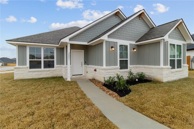 craftsman-style home with a front yard