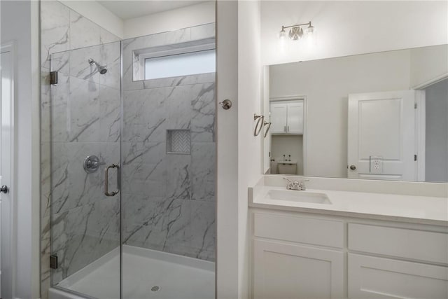 bathroom featuring vanity and a shower with door