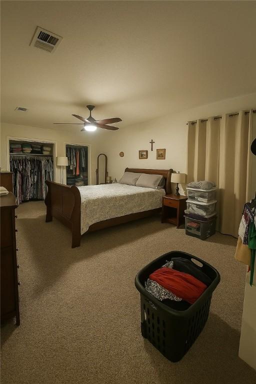 2106 Labrisa Dr, Bryan, TX 77807 - bedroom featuring carpet floors, ceiling fan, and multiple closets