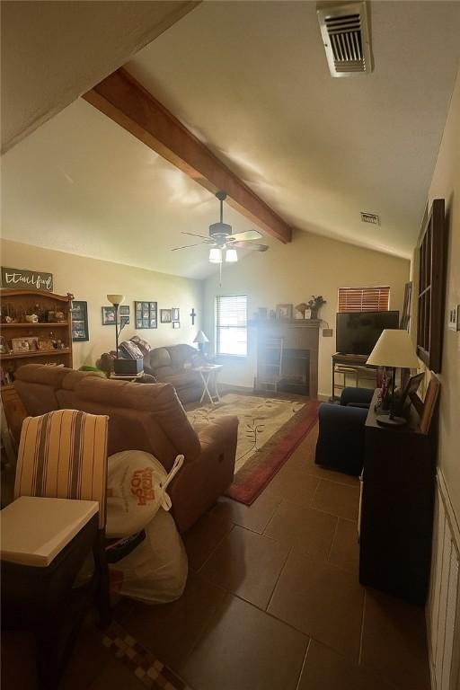 2106 Labrisa Dr, Bryan, TX 77807 - tiled living room with ceiling fan and a fireplace