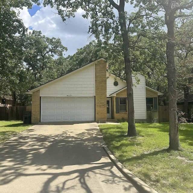 2106 Labrisa Dr, Bryan, TX 77807 - mid-century inspired home featuring concrete driveway, an attached garage, and brick siding