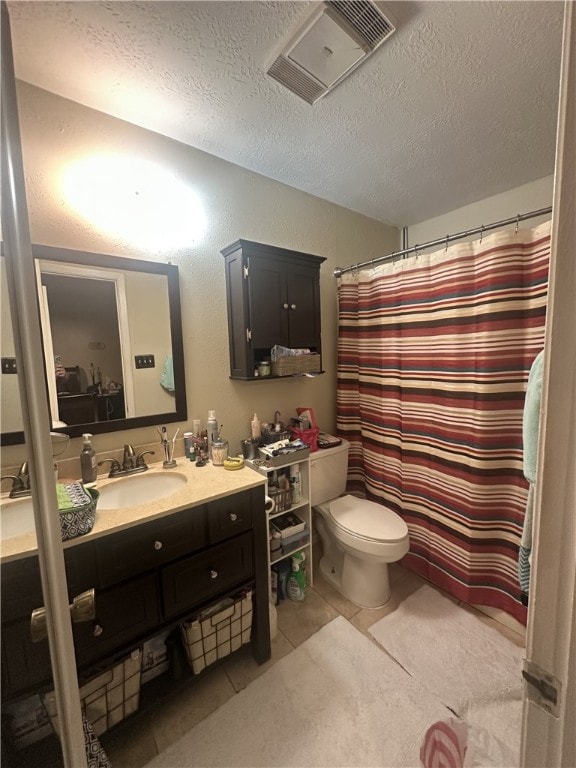 2106 Labrisa Dr, Bryan, TX 77807 - bathroom featuring a textured ceiling, vanity, tile patterned floors, and curtained shower