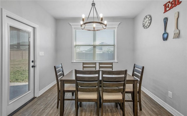 dining space featuring plenty of natural light, dark hardwood / wood-style floors, and a notable chandelier