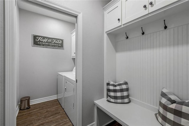 laundry room with washer and dryer, dark hardwood / wood-style flooring, and cabinets