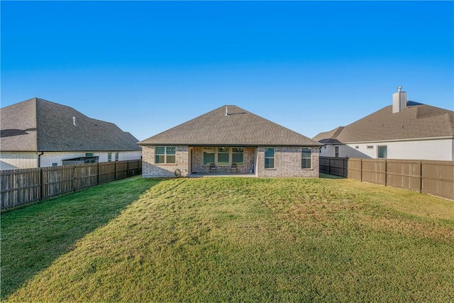 rear view of house with a yard