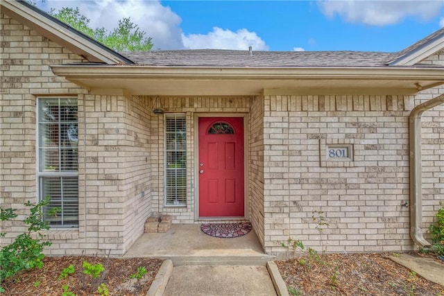801 Camellia Ct, College Station, TX 77840 - view of exterior entry featuring a shingled roof and brick siding