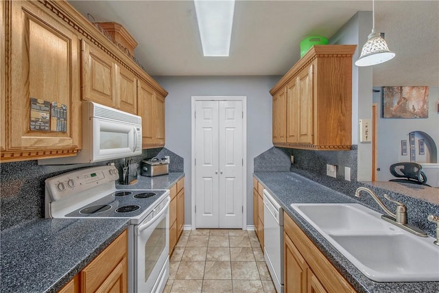 801 Camellia Ct, College Station, TX 77840 - kitchen with white appliances, a sink, decorative backsplash, dark countertops, and hanging light fixtures
