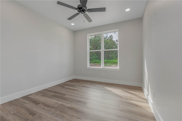 empty room featuring ceiling fan and light hardwood / wood-style floors