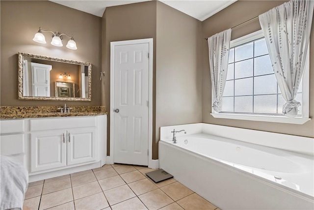 bathroom featuring tile patterned floors, a garden tub, and vanity