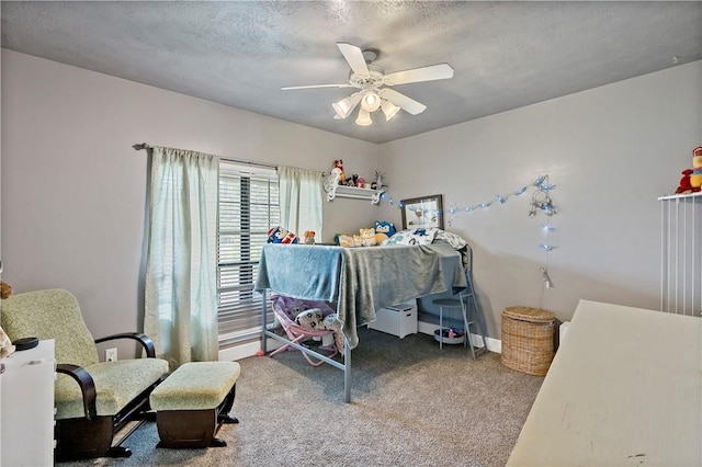 carpeted bedroom with ceiling fan and a textured ceiling