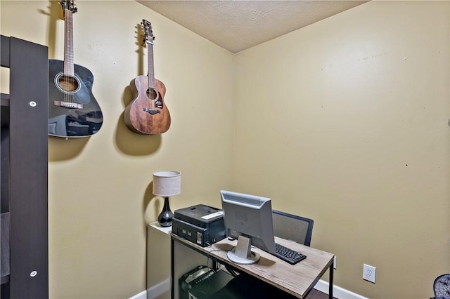 office featuring baseboards and a textured ceiling