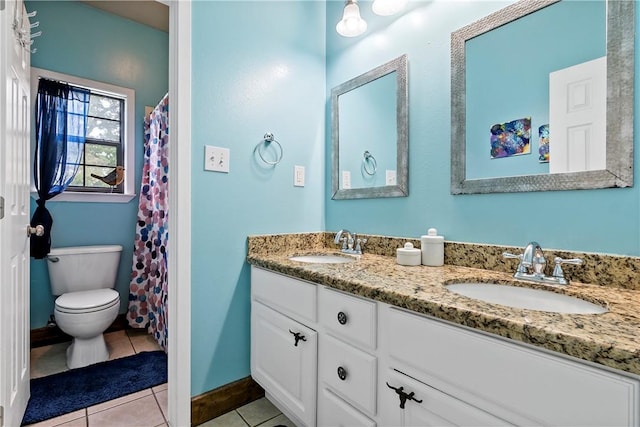 bathroom featuring toilet, tile patterned flooring, double vanity, and a sink