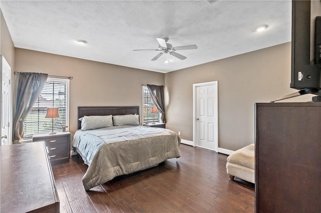 bedroom featuring baseboards, dark wood-style flooring, and ceiling fan