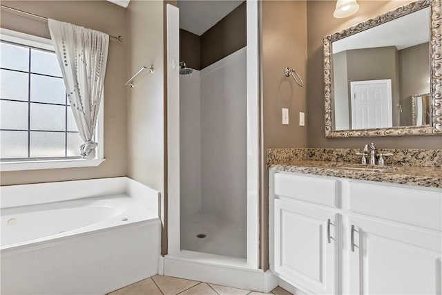 full bath with vanity, plenty of natural light, and a stall shower