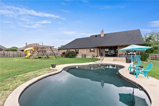 view of pool featuring a playground, a lawn, a fenced backyard, a patio area, and a fenced in pool