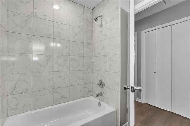 bathroom with wood-type flooring and tiled shower / bath combo