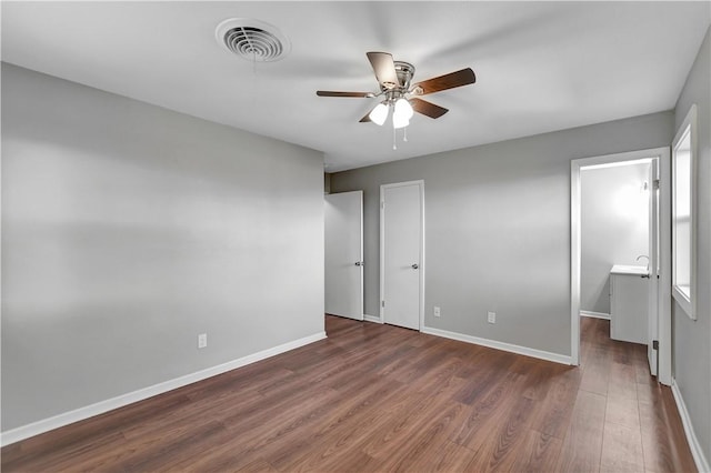 unfurnished bedroom with dark wood-type flooring and ceiling fan