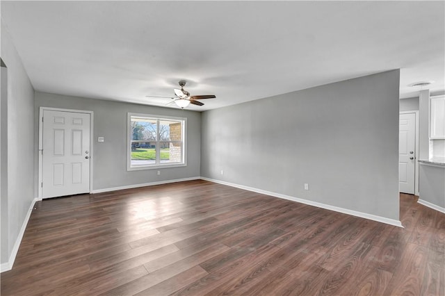 unfurnished room featuring dark wood-type flooring and ceiling fan