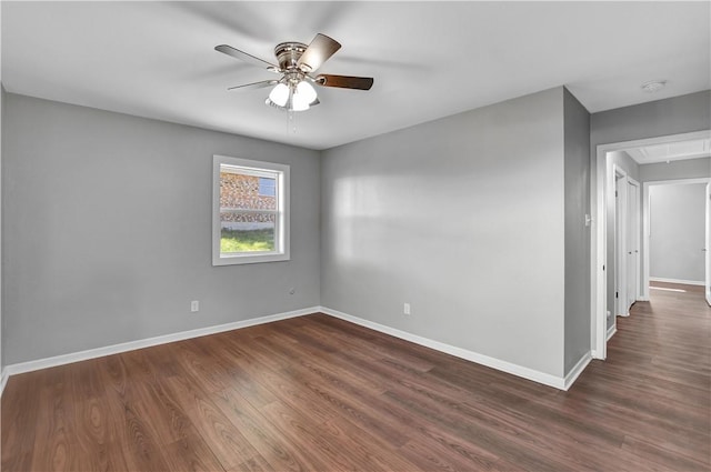 spare room with dark hardwood / wood-style floors and ceiling fan