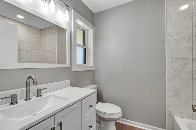 full bathroom featuring vanity, toilet, and tiled shower / bath combo