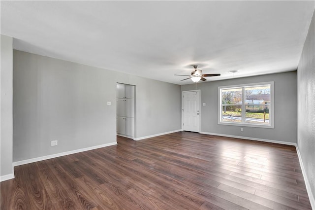 spare room featuring ceiling fan and dark hardwood / wood-style flooring