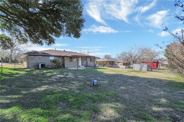 view of yard featuring a storage shed, a patio, and central air condition unit