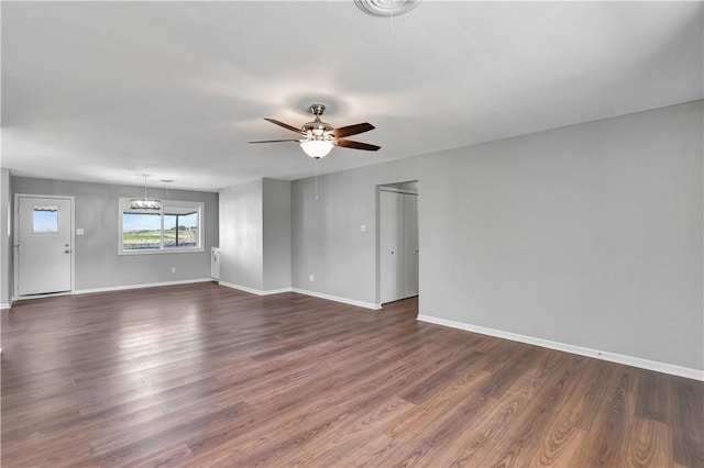 unfurnished living room with dark hardwood / wood-style floors and ceiling fan