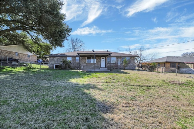 rear view of property featuring a yard