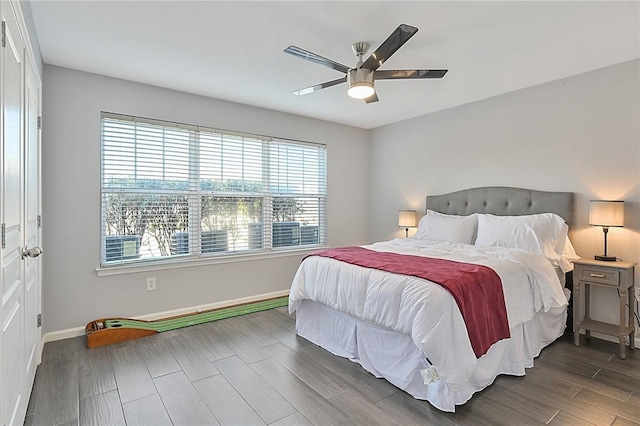 bedroom with ceiling fan, wood finish floors, and baseboards