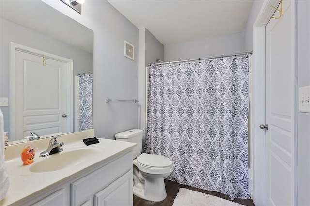 bathroom with curtained shower, visible vents, toilet, vanity, and wood finished floors