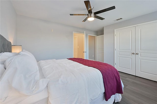 bedroom featuring a closet, visible vents, ceiling fan, and wood finished floors