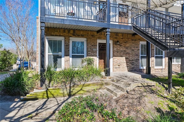 view of exterior entry with brick siding