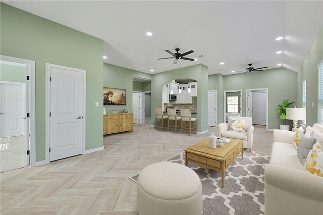 living room with light parquet floors and ceiling fan