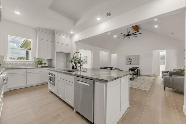 kitchen featuring ceiling fan, white cabinetry, sink, an island with sink, and appliances with stainless steel finishes