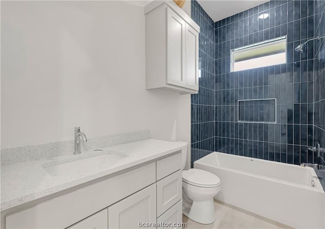 full bathroom with toilet, vanity, and tiled shower / bath