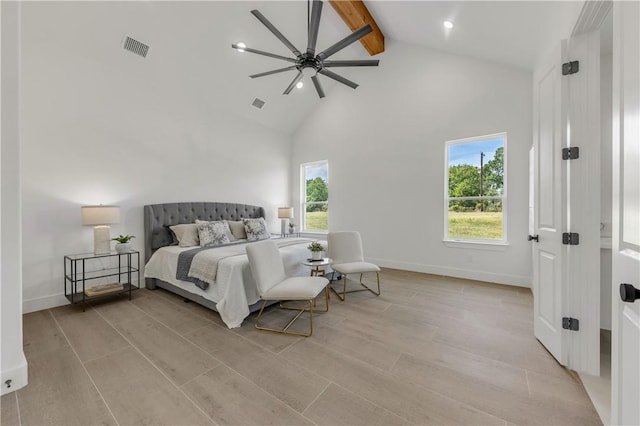 bedroom featuring beam ceiling, light hardwood / wood-style floors, high vaulted ceiling, and ceiling fan