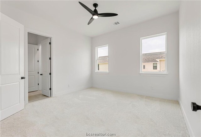 unfurnished bedroom featuring ceiling fan and light carpet