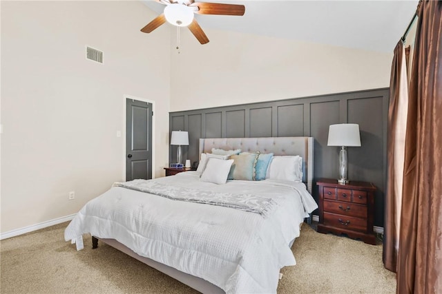 6866 Wooded Dr, College Station, TX 77845 - bedroom featuring light carpet, a decorative wall, a wainscoted wall, ceiling fan, and high vaulted ceiling