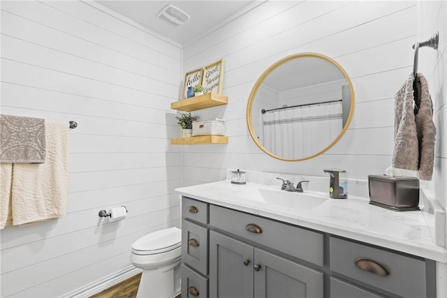 6866 Wooded Dr, College Station, TX 77845 - full bathroom featuring vanity, wooden walls, and wood finished floors