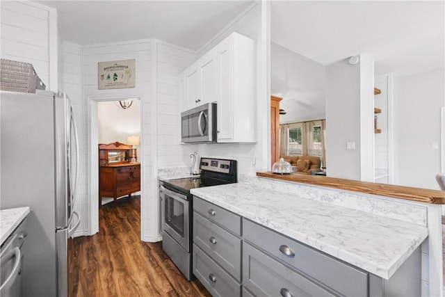 6866 Wooded Dr, College Station, TX 77845 - kitchen featuring appliances with stainless steel finishes, gray cabinetry, dark wood-type flooring, a peninsula, and white cabinets
