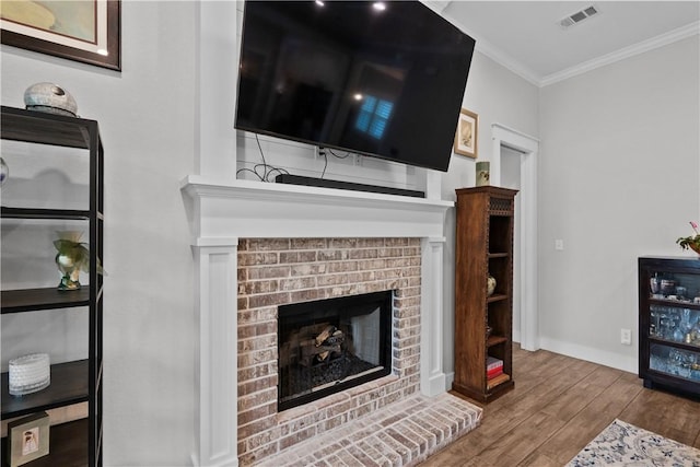1909 Bareboot Trl, College Station, TX 77845 - living room with crown molding, wood finished floors, and a brick fireplace
