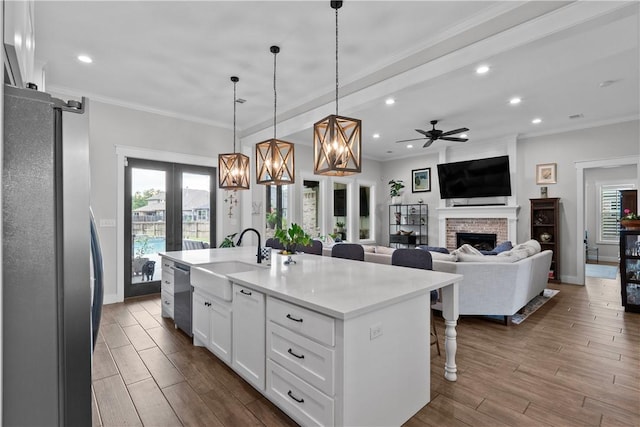1909 Bareboot Trl, College Station, TX 77845 - kitchen with stainless steel appliances, french doors, plenty of natural light, white cabinets, and recessed lighting